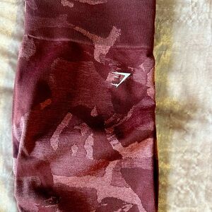 Gymshark red patterned workout compression leggings.